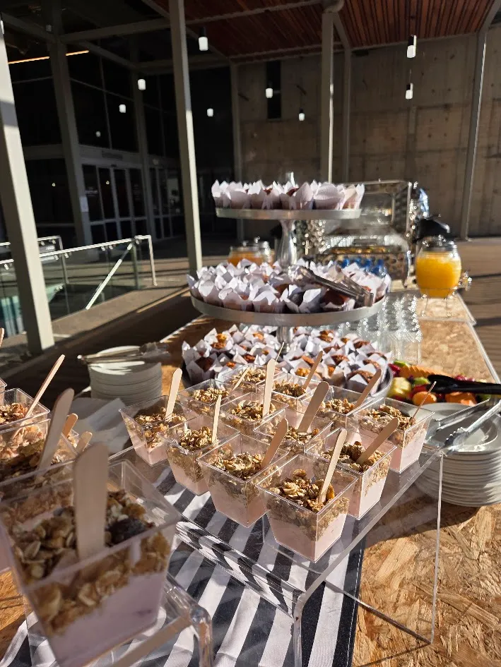 breakfast station set up by Oh Mai Catering featuring muesli fruit platters muffins juice stations and hot chafing dish for a catering service in Pretoria